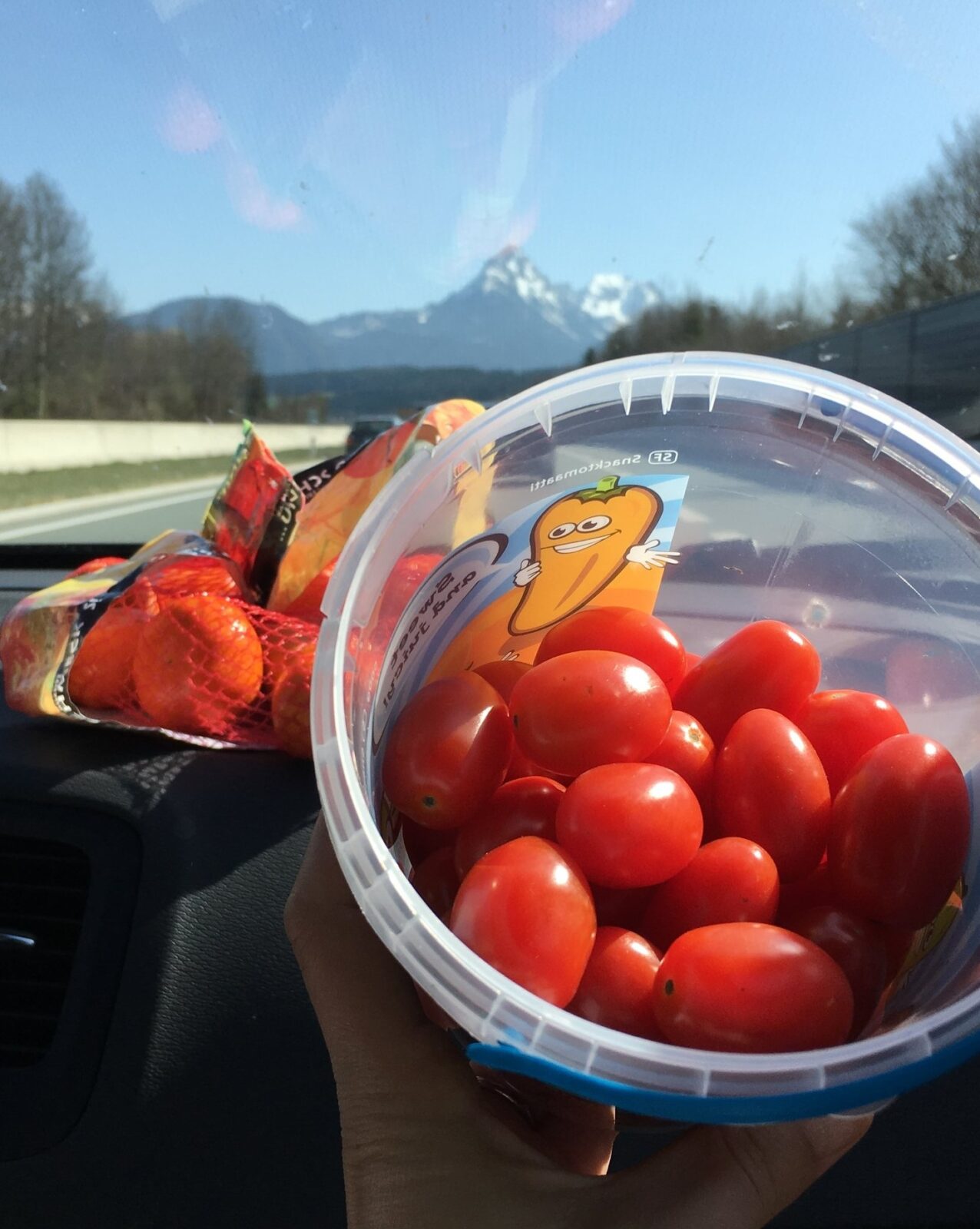 Road trip snacks of strawberries, mandarins and cherry tomatoes help me stay balanced and get enough fruit and veg - this is definitely part of my healthy travel tips list. Image: Lyndi Cohen 