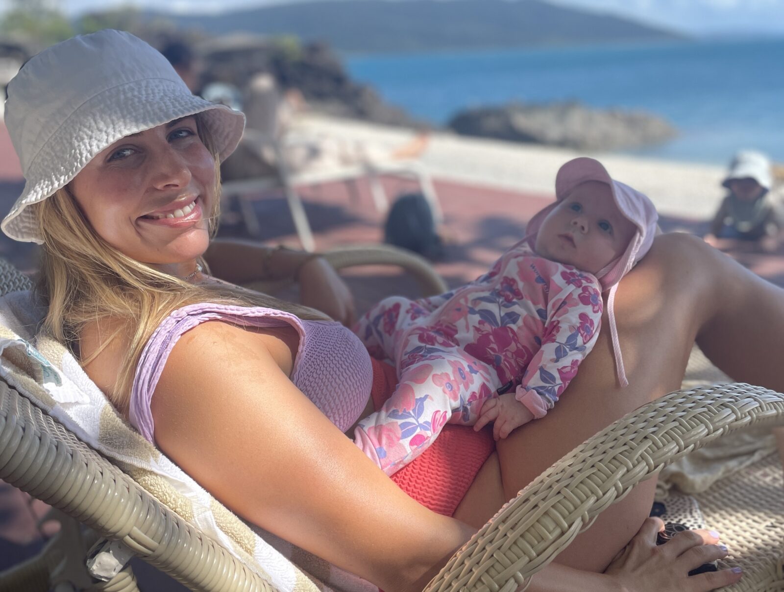 Lyndi Cohen with her daughter on a chair by the water